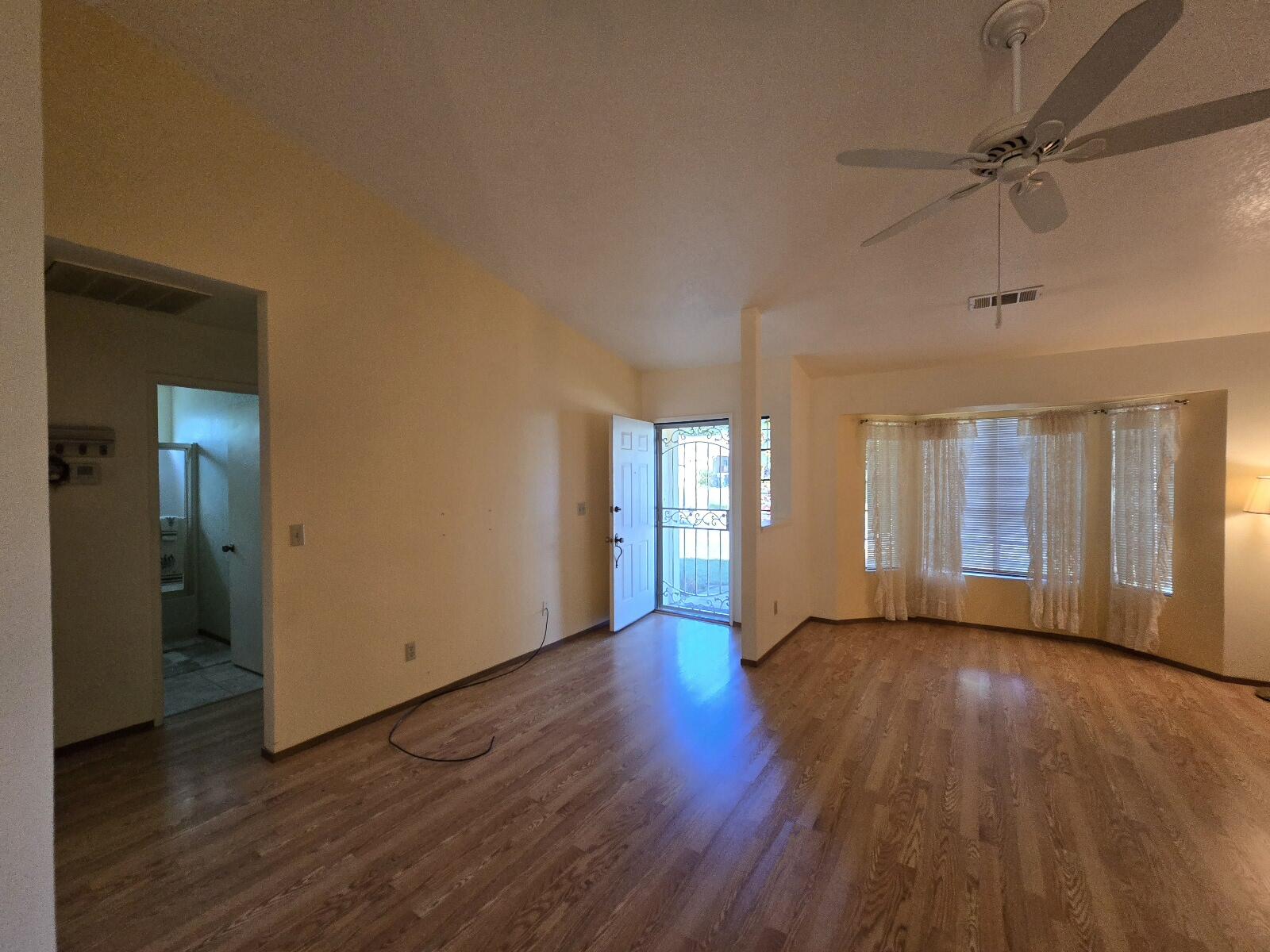 3671 Santa Rosa Way Redding, CA 96003 - Photo 16 of 26 a view of an empty room with wooden floor and a window