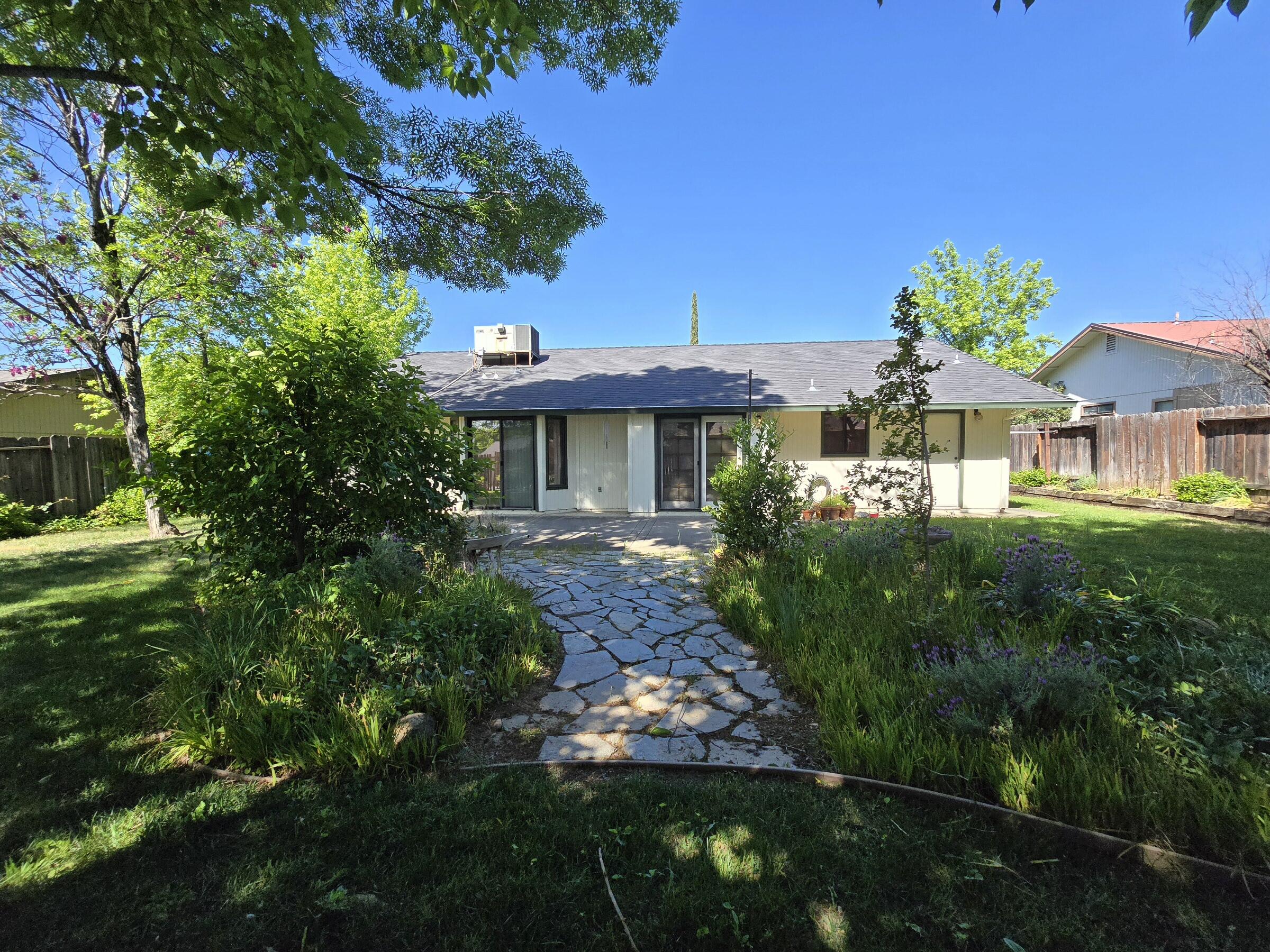 3671 Santa Rosa Way Redding, CA 96003 - Photo 20 of 26 a front view of a house with a garden