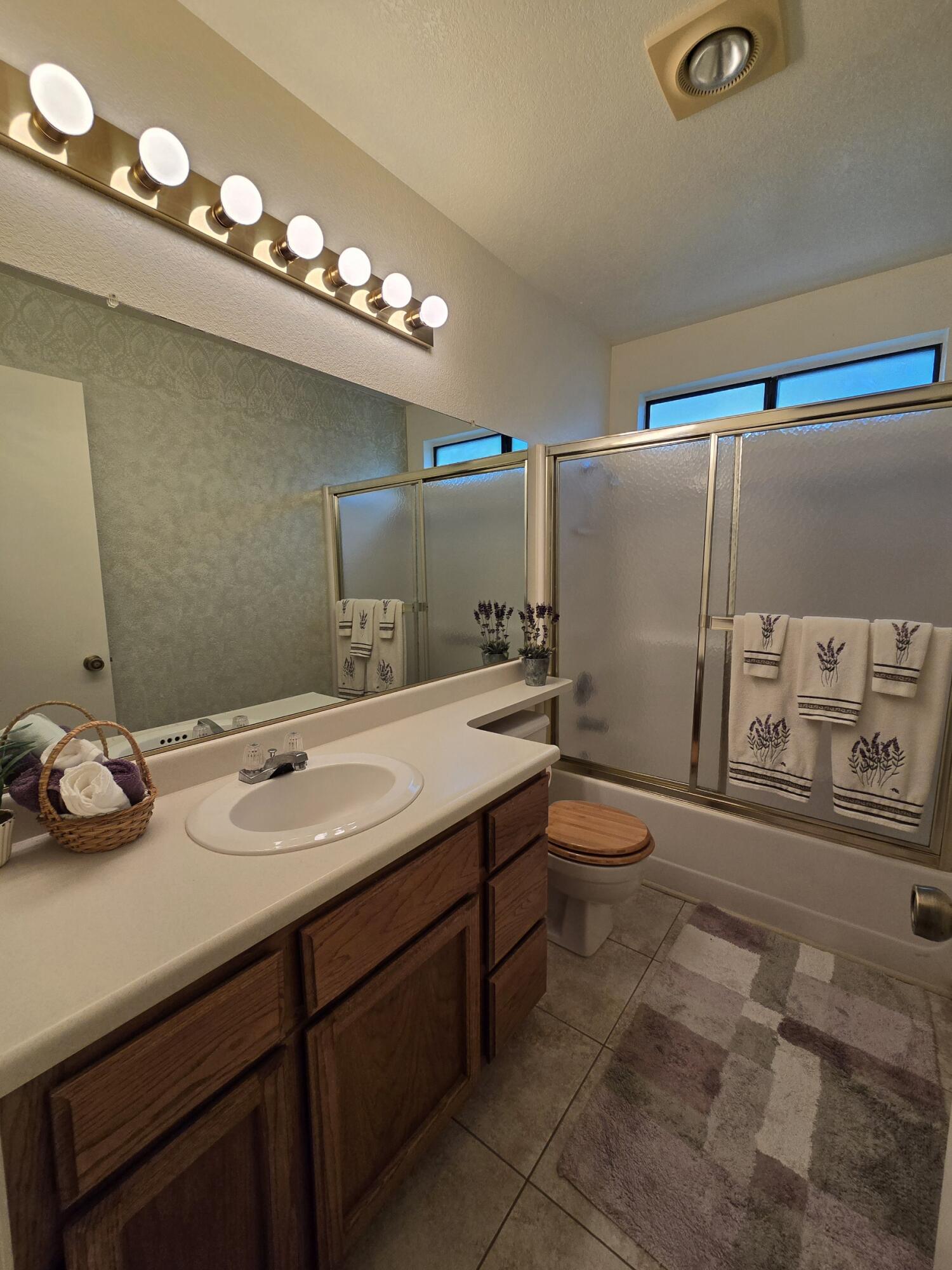 3671 Santa Rosa Way Redding, CA 96003 - Photo 5 of 26 a bathroom with a granite countertop sink a toilet and a mirror