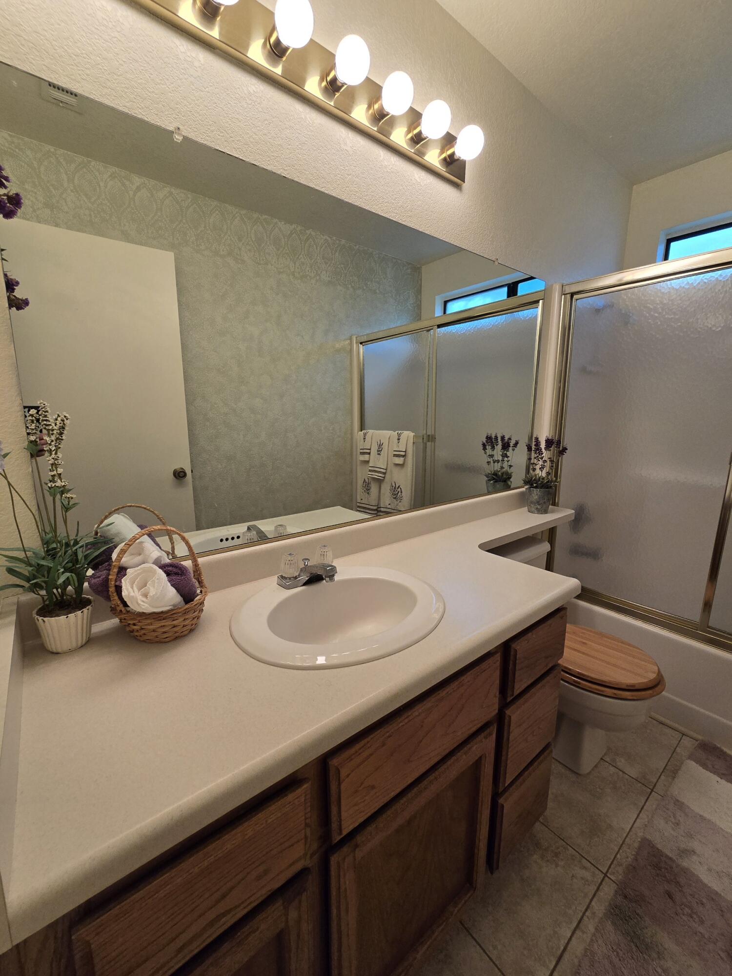 3671 Santa Rosa Way Redding, CA 96003 - Photo 7 of 26 a bathroom with a sink a toilet and mirror