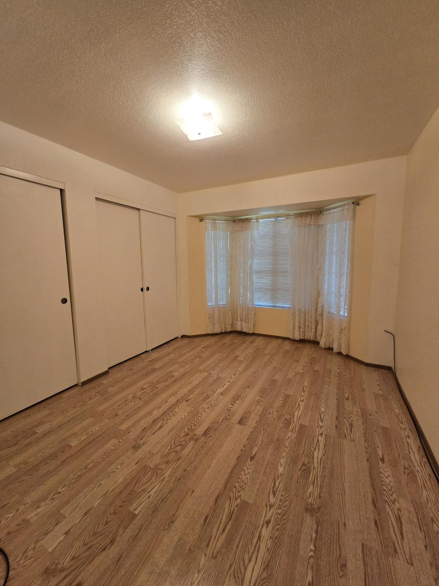 3671 Santa Rosa Way Redding, CA 96003 - Photo 8 of 26 a view of an empty room with wooden floor