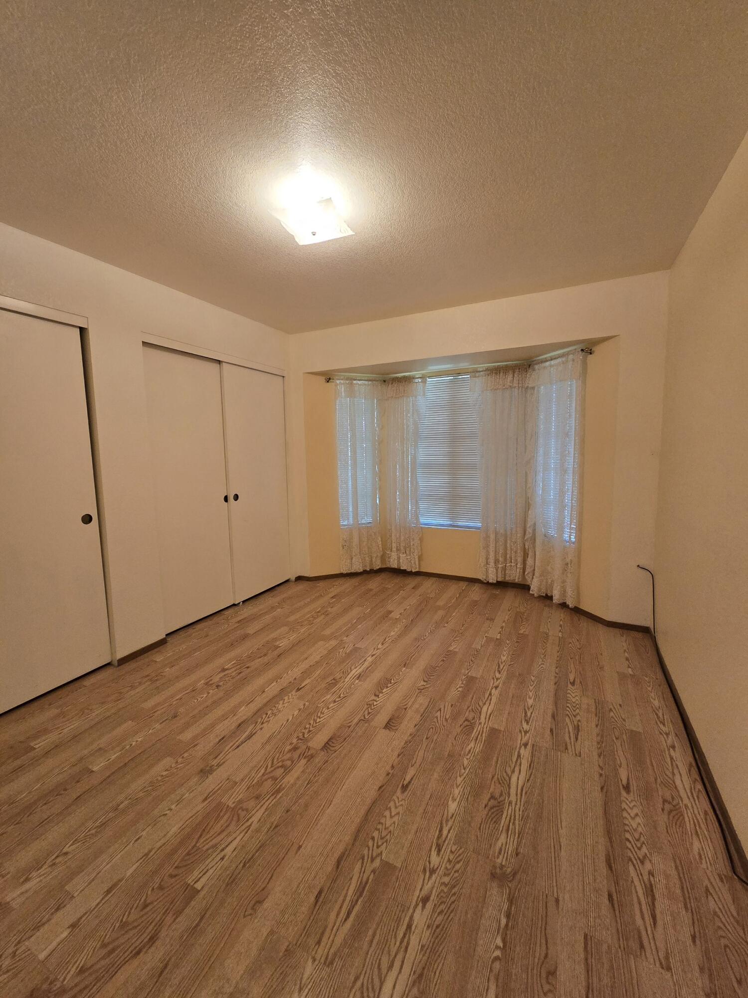3671 Santa Rosa Way Redding, CA 96003 - Photo 9 of 26 a view of an empty room with wooden floor