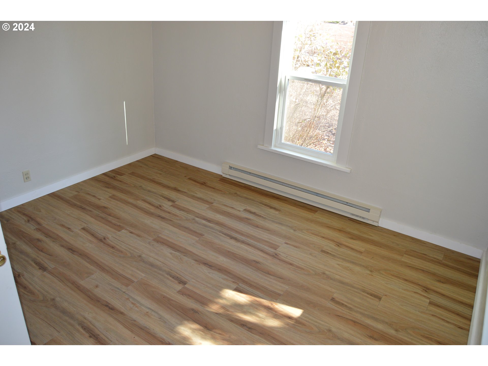 705 Couch Avenue Wallowa, OR 97885 - Photo 16 of 35 a view of empty room with wooden floor