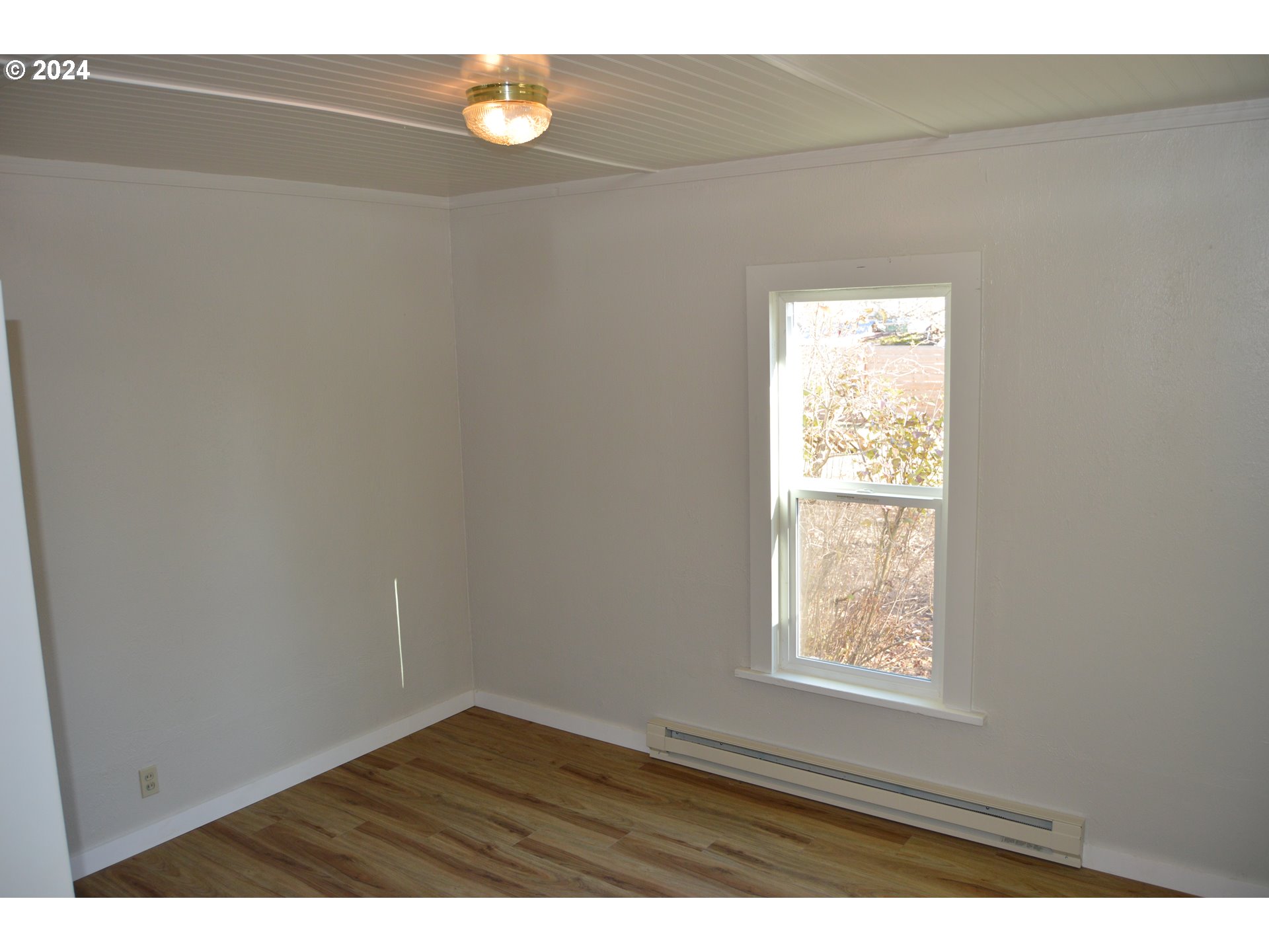 705 Couch Avenue Wallowa, OR 97885 - Photo 17 of 35 a view of an empty room and window