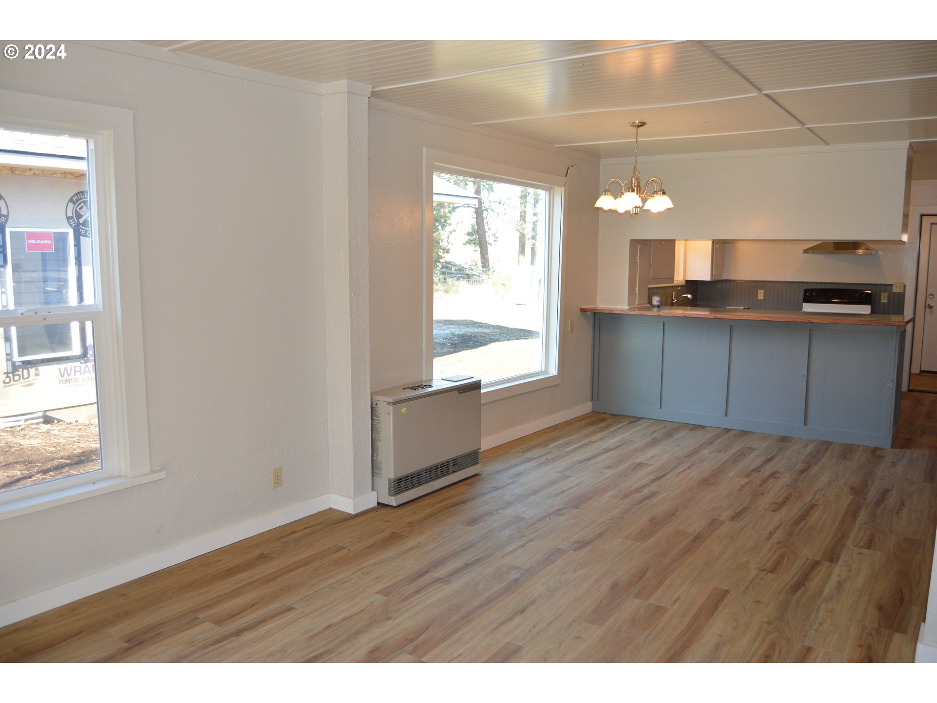 705 Couch Avenue Wallowa, OR 97885 - Photo 18 of 35 a kitchen with a wooden floor and a window