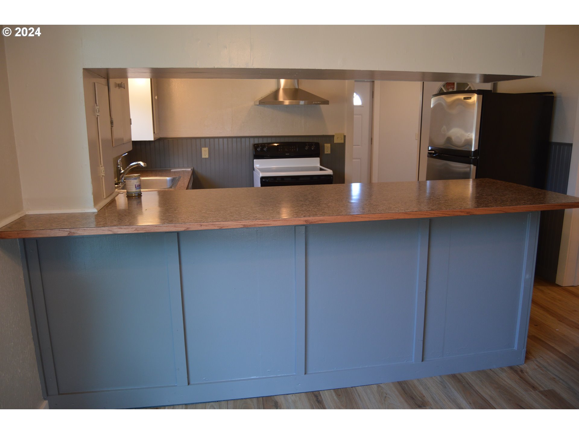 705 Couch Avenue Wallowa, OR 97885 - Photo 19 of 35 a kitchen with stainless steel appliances a sink and cabinets
