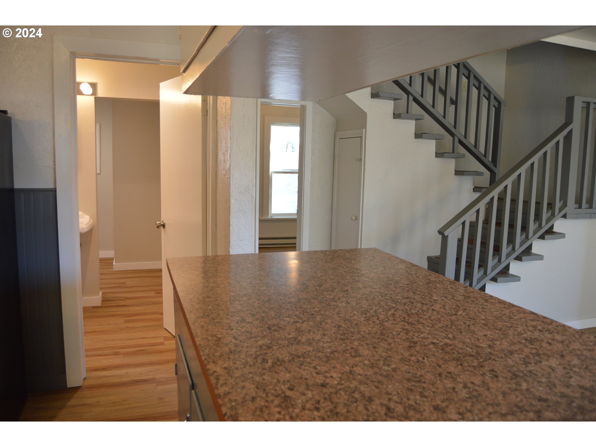 705 Couch Avenue Wallowa, OR 97885 - Photo 26 of 35 a view of a hallway with wooden floor and staircase