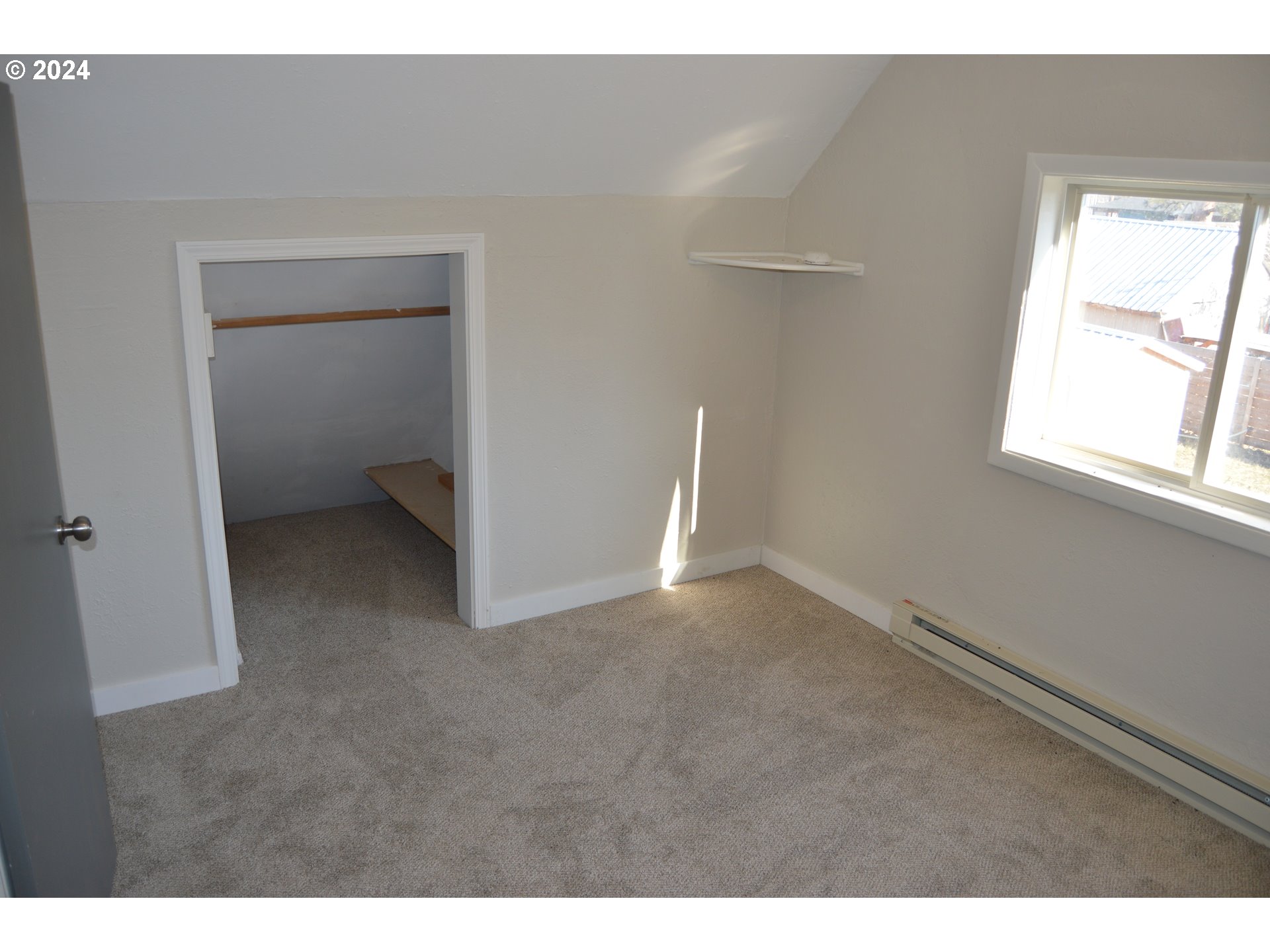 705 Couch Avenue Wallowa, OR 97885 - Photo 9 of 35 a view of an empty room with a window