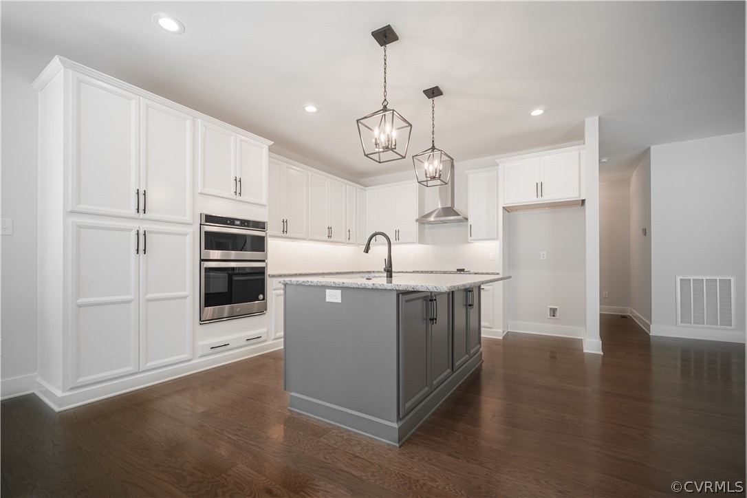 3641 East Rocketts Ridge Road Sandy Hook, VA 23153 - Photo 5 of 17 a kitchen with stainless steel appliances a stove a sink and white cabinets