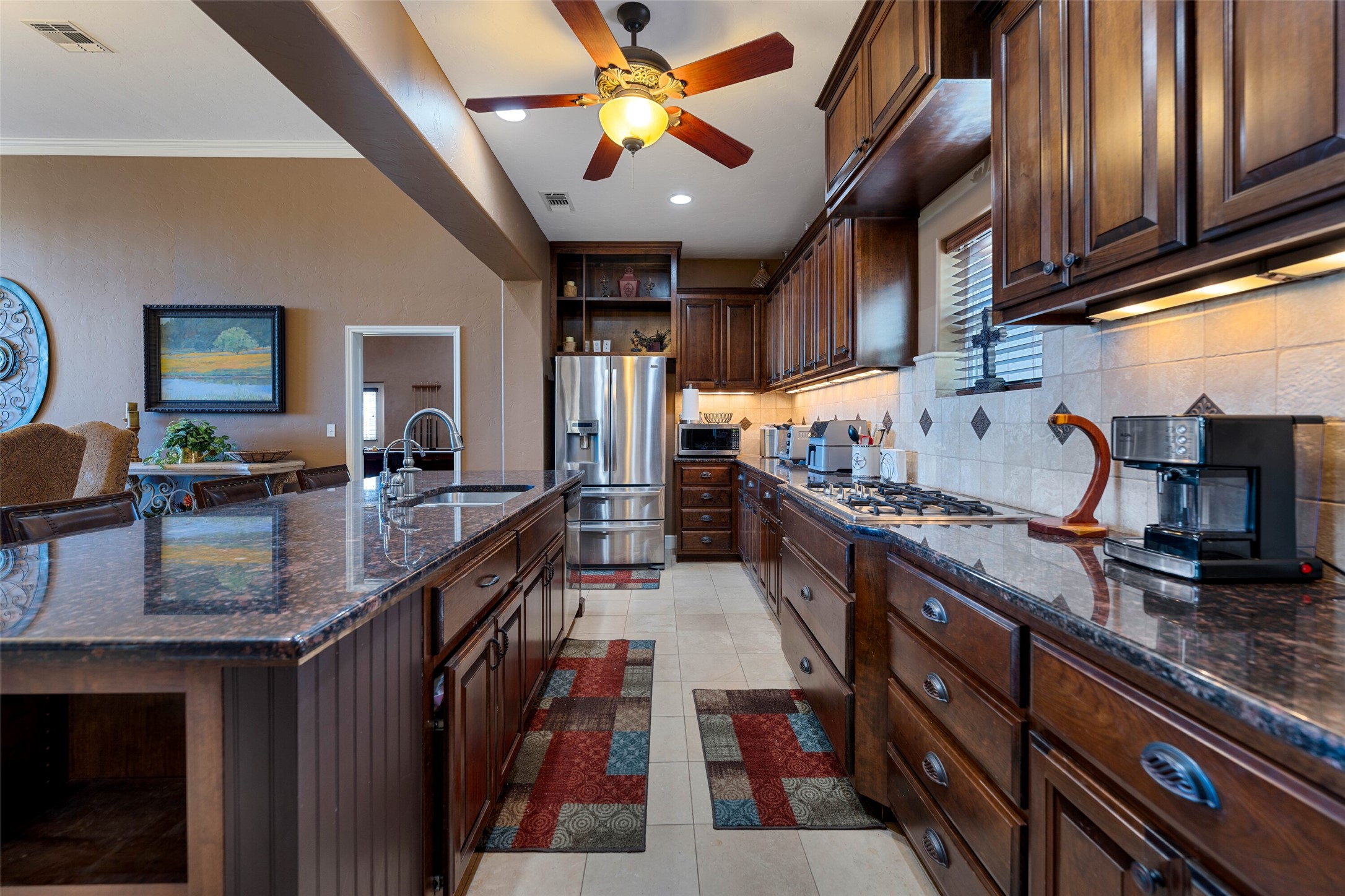 7702 Ranch Road 965 Llano, TX 78643 - Photo 8 of 40 a kitchen with stainless steel appliances granite countertop a stove a sink dishwasher and cabinets with wooden floor