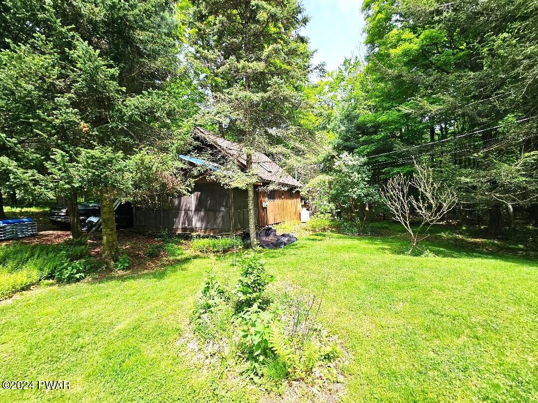 181 Highland Road Pleasant Mount, PA 18453 - Photo 5 of 18 a yellow house in middle of the forest