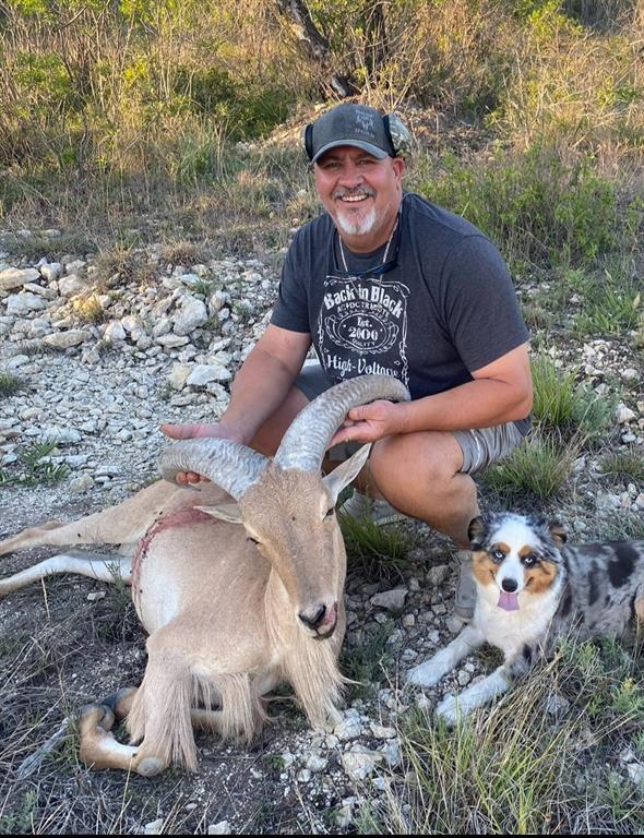 144 Walnut Springs Walnut Springs, TX 76690 - Photo 14 of 14 a view of a backyard with table and chairs