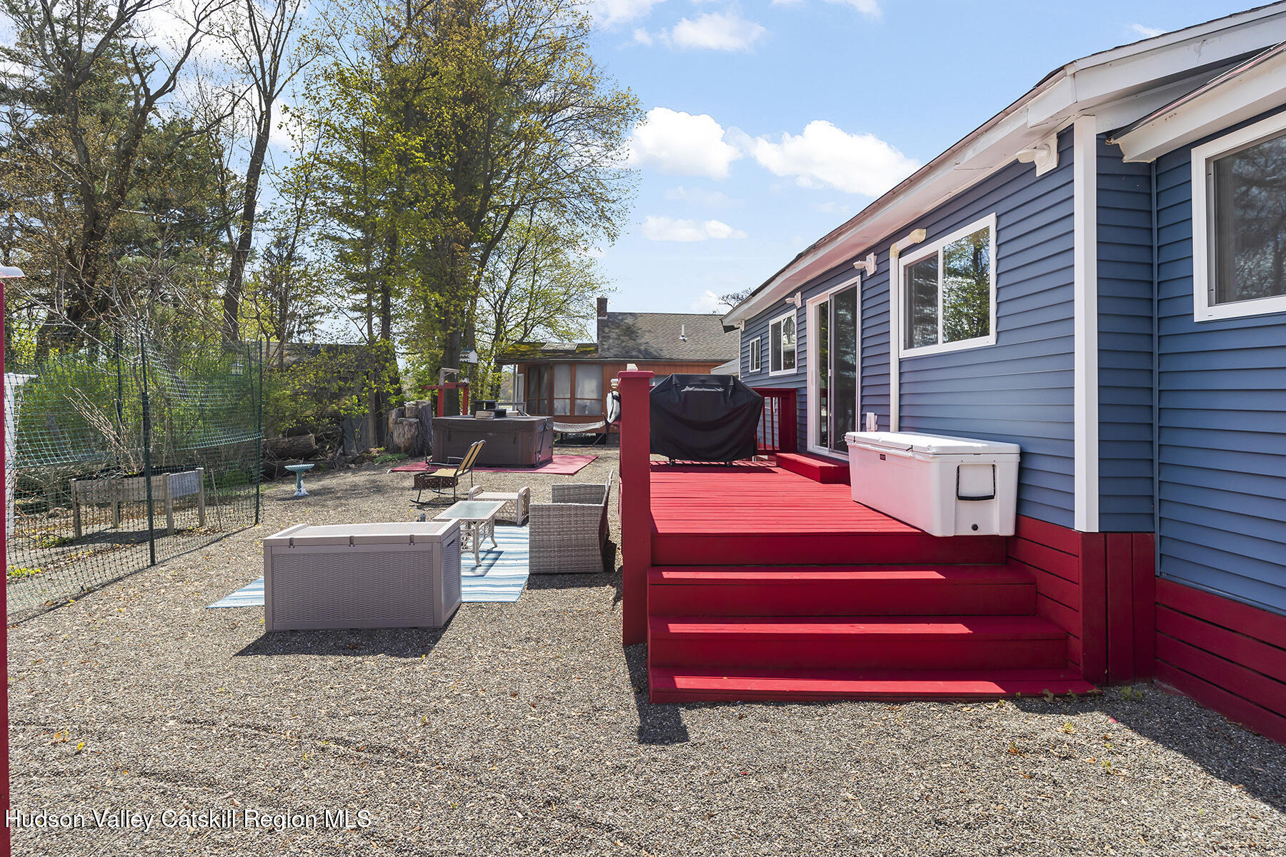 16 Robin Road Copake, NY 12521 - Photo 15 of 23 a backyard of a house with barbeque oven and outdoor seating