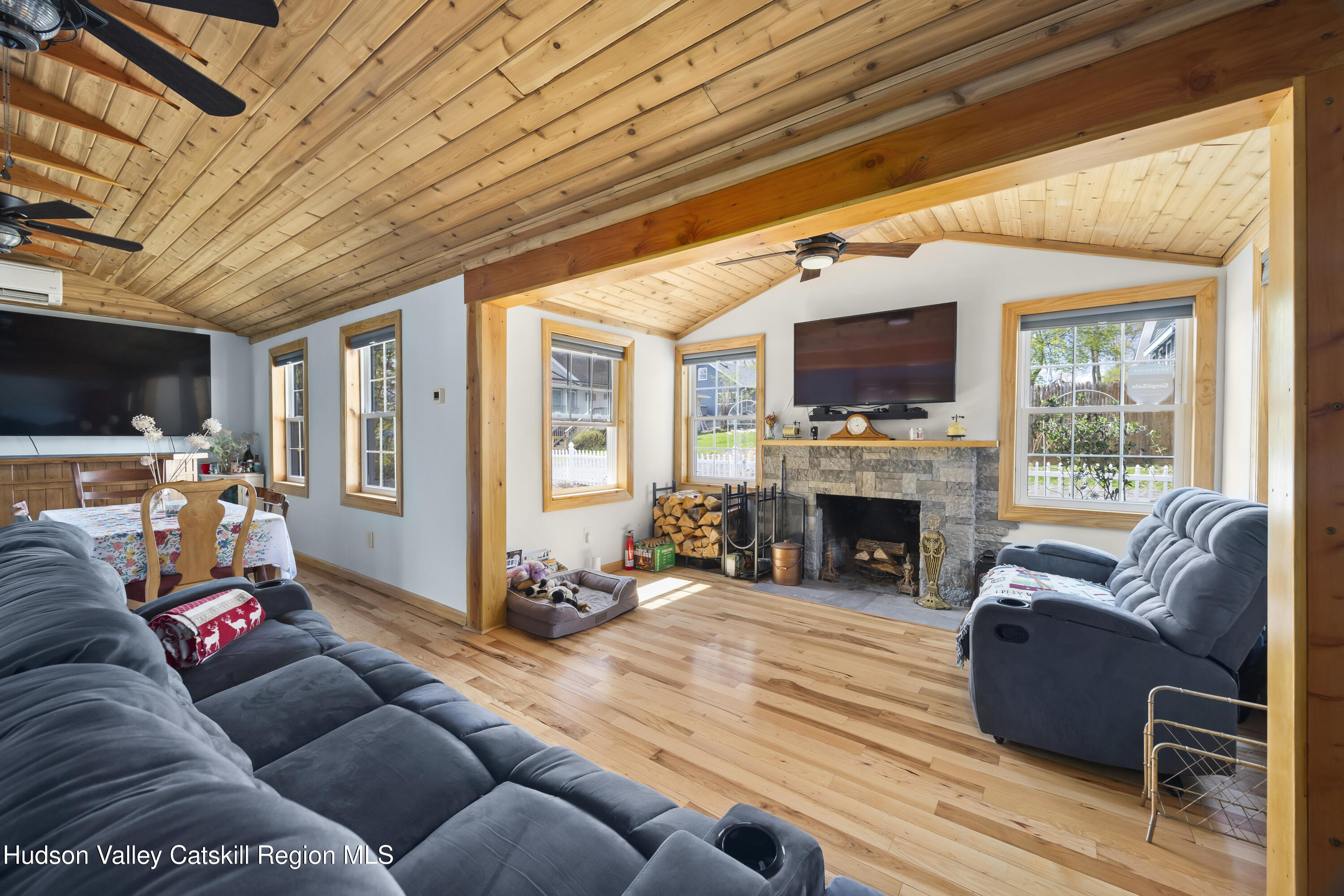 16 Robin Road Copake, NY 12521 - Photo 4 of 23 a living room with furniture a fireplace and a flat screen tv