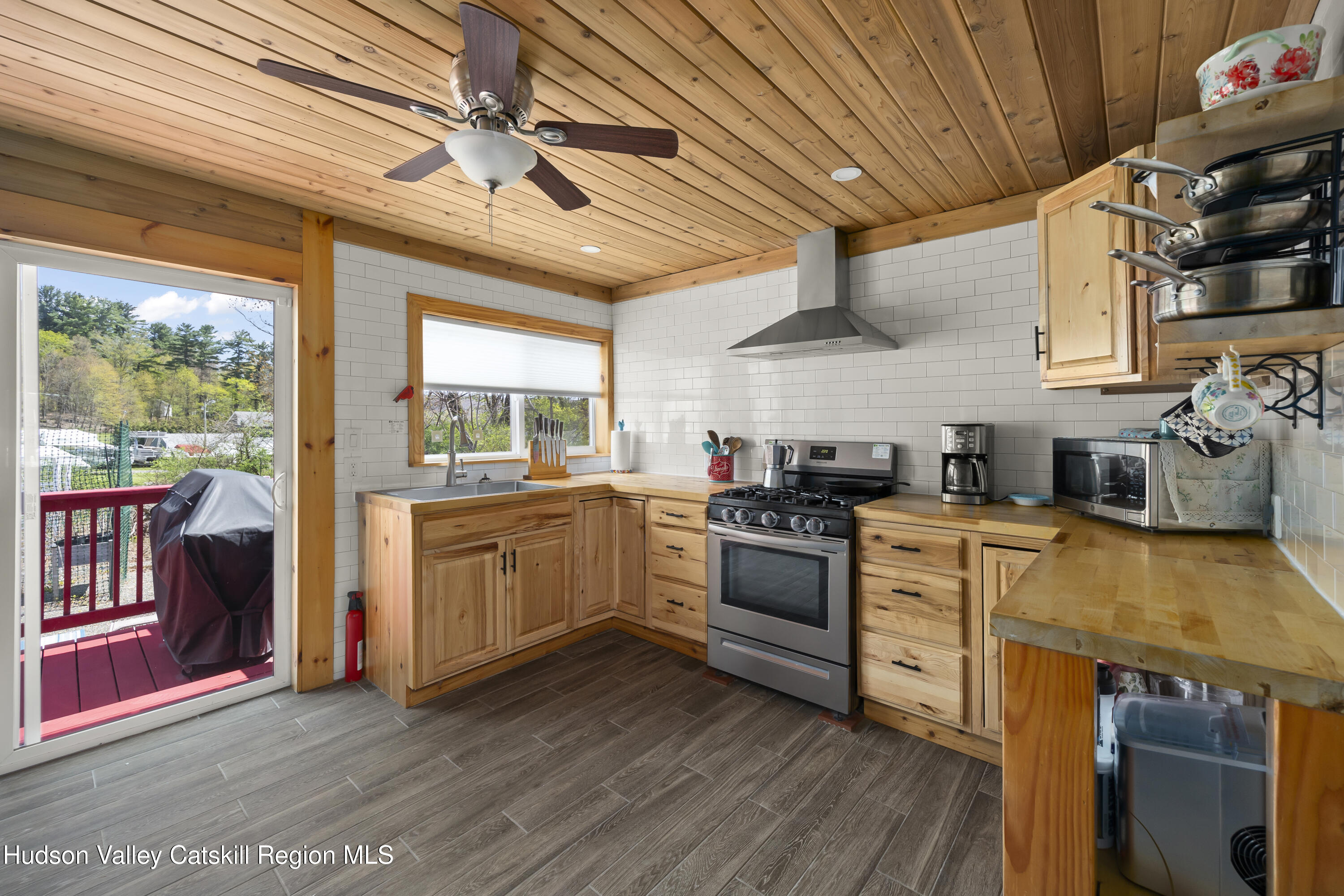 16 Robin Road Copake, NY 12521 - Photo 10 of 23 a kitchen with stainless steel appliances granite countertop a sink stove and wooden floor