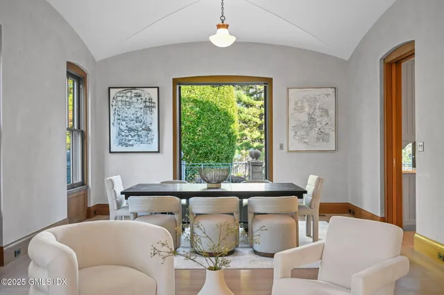 a living room with patio furniture and a large window