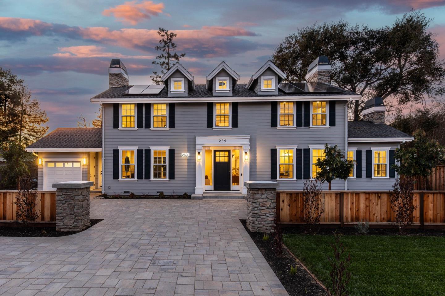 front view of a brick house with a yard