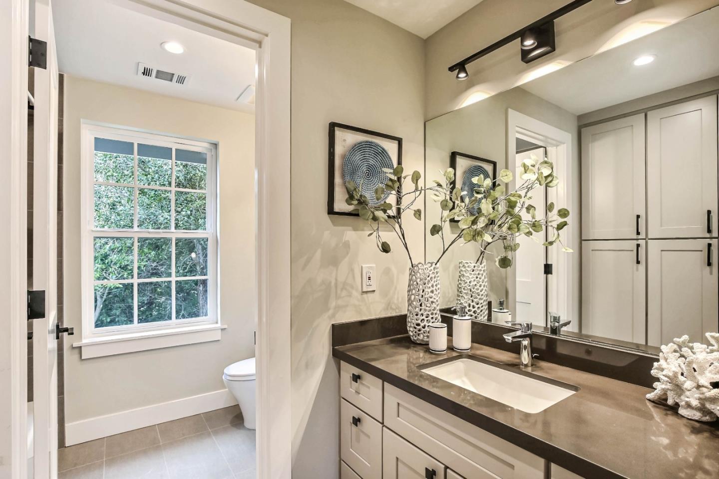 269 Willow Road Menlo Park, CA 94025 - Photo 12 of 26 a bathroom with a granite countertop sink a mirror and a shower
