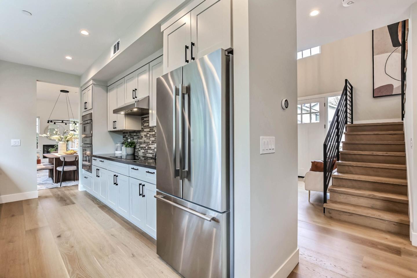 269 Willow Road Menlo Park, CA 94025 - Photo 5 of 26 a kitchen with stainless steel appliances a refrigerator sink and cabinets