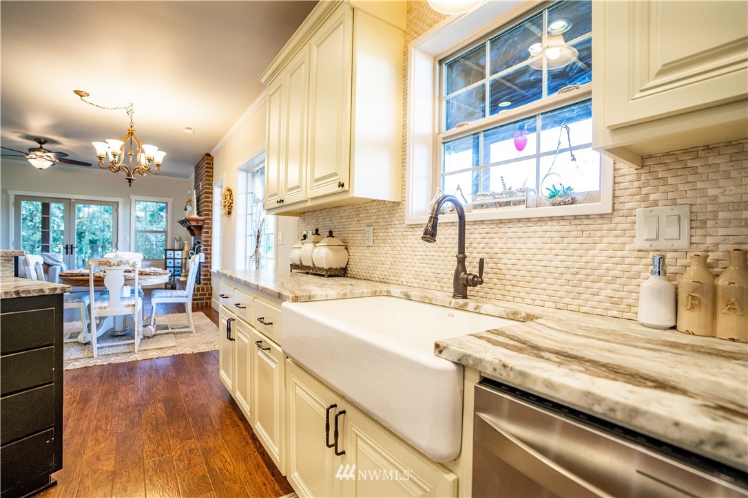 3116 Jackson Highway Chehalis, WA 98532 - Photo 13 of 40 a kitchen with a sink and wooden floor