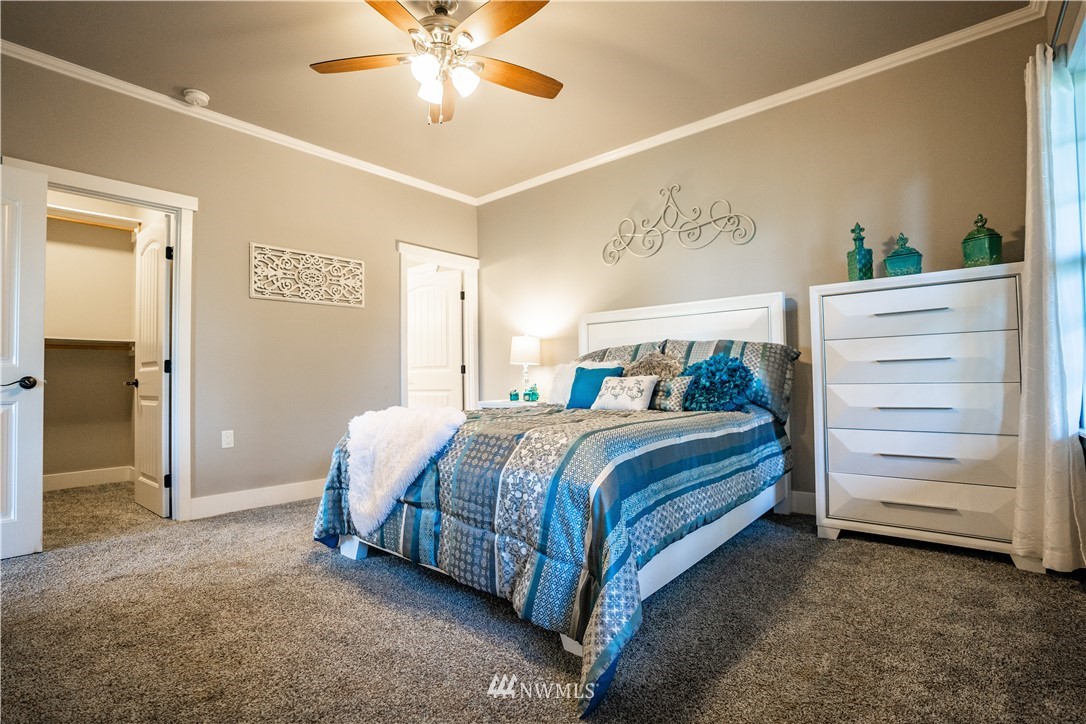 3116 Jackson Highway Chehalis, WA 98532 - Photo 18 of 40 a bedroom with a bed and a chandelier