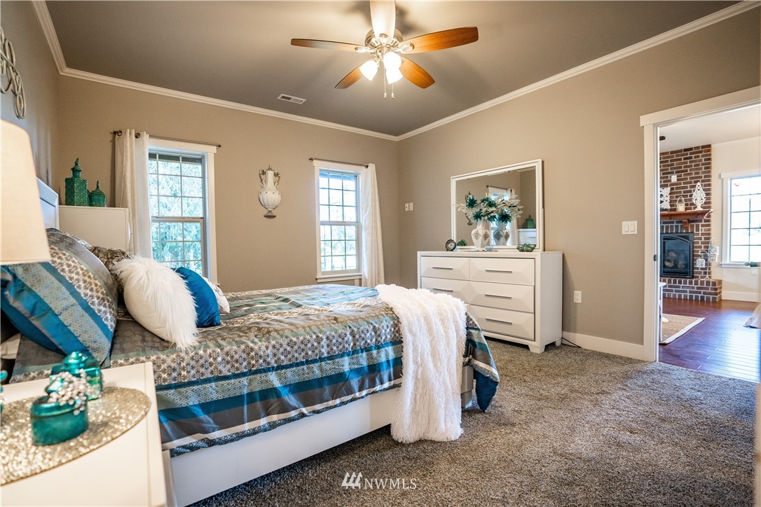 3116 Jackson Highway Chehalis, WA 98532 - Photo 20 of 40 a bedroom with a bed and ceiling fan