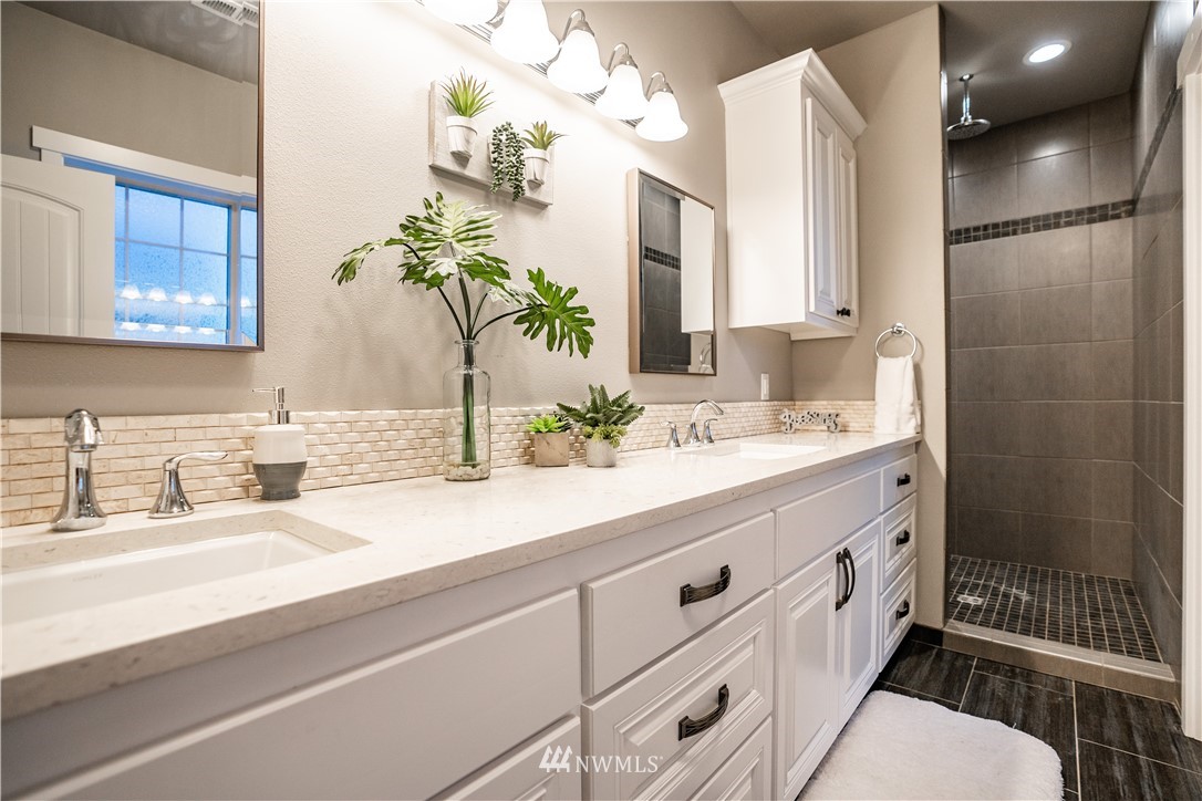 3116 Jackson Highway Chehalis, WA 98532 - Photo 23 of 40 a bathroom with double vanity sink a mirror and a shower