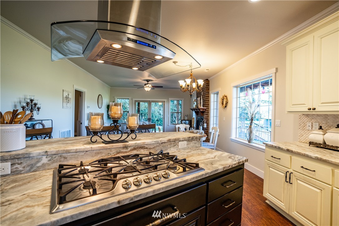 3116 Jackson Highway Chehalis, WA 98532 - Photo 8 of 40 a kitchen with a stove a sink and a refrigerator