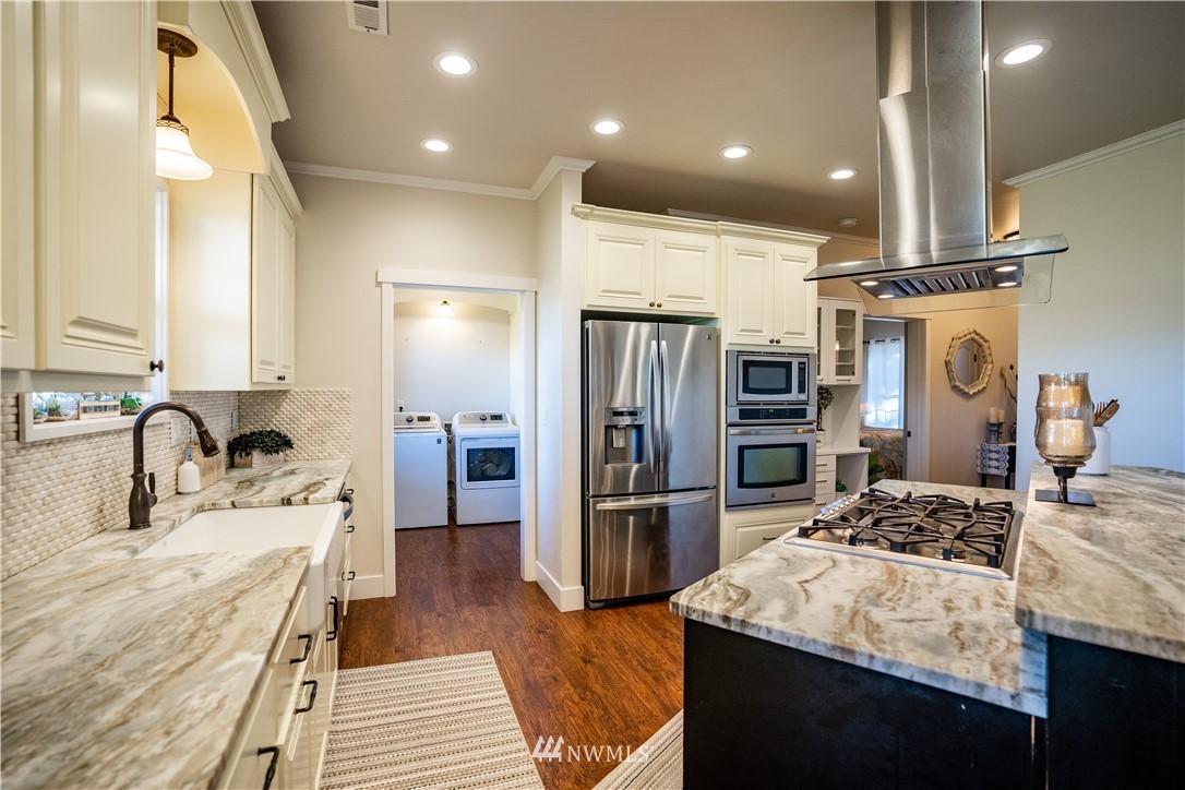 3116 Jackson Highway Chehalis, WA 98532 - Photo 10 of 40 a kitchen with kitchen island granite countertop a sink stove and refrigerator