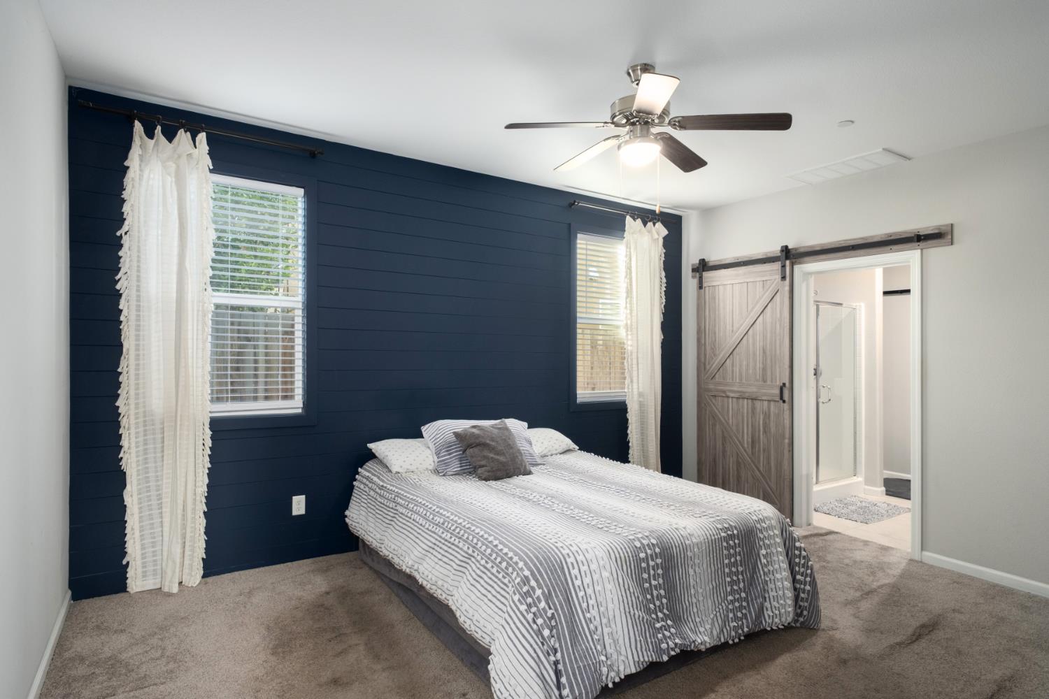 153 Drake Street Madera, CA 93638 - Photo 13 of 34 a bedroom with a bed and a chandelier