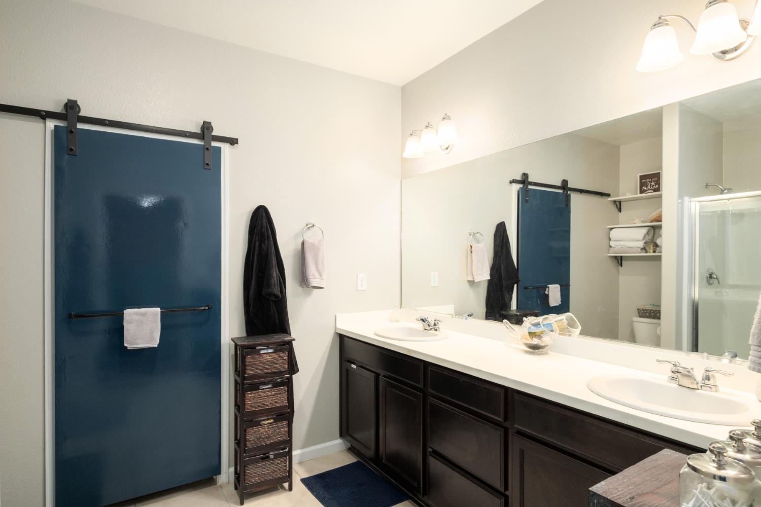 153 Drake Street Madera, CA 93638 - Photo 14 of 34 a bathroom with a double vanity sink and mirror