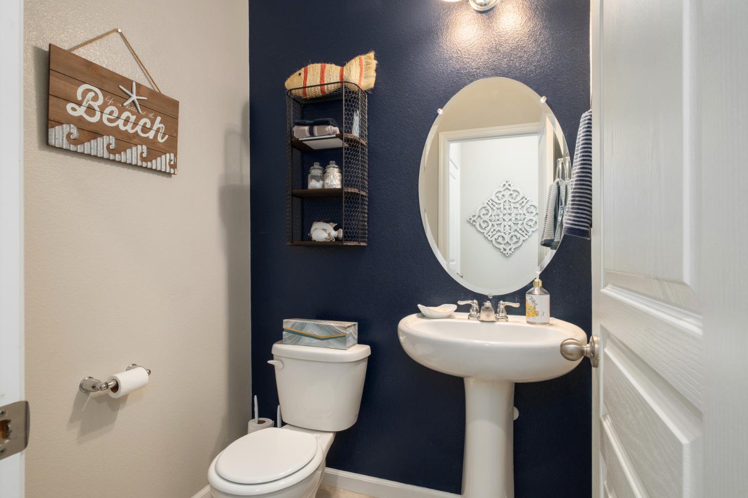 153 Drake Street Madera, CA 93638 - Photo 16 of 34 a bathroom with a toilet sink and mirror