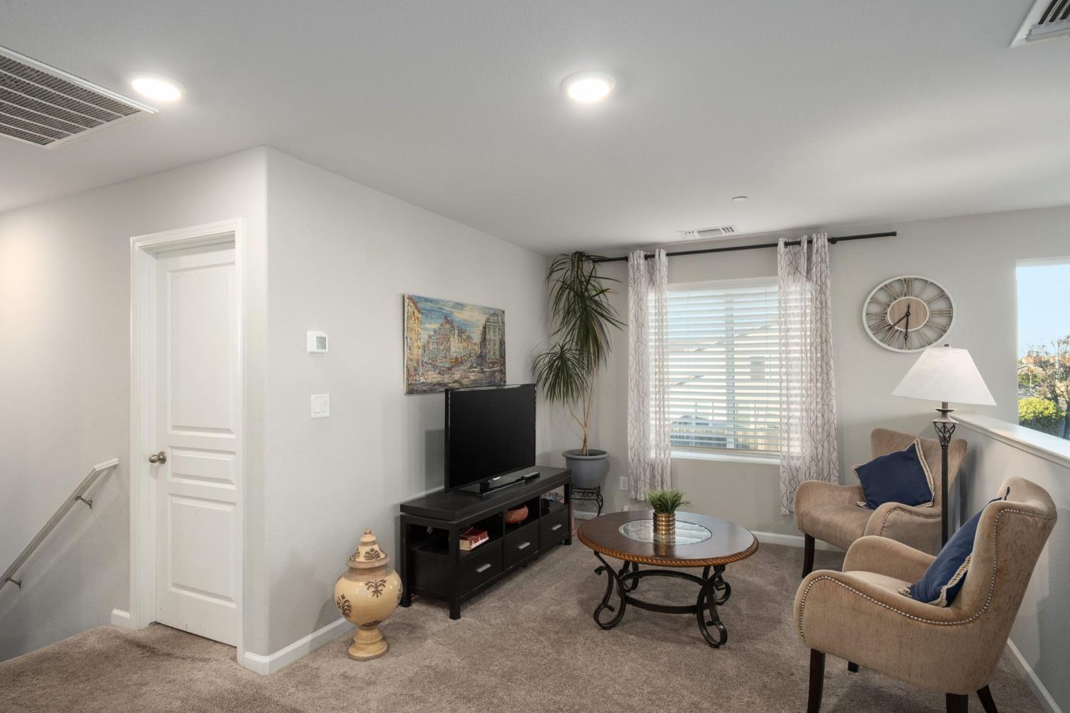 153 Drake Street Madera, CA 93638 - Photo 21 of 34 a living room with furniture a window and a flat screen tv