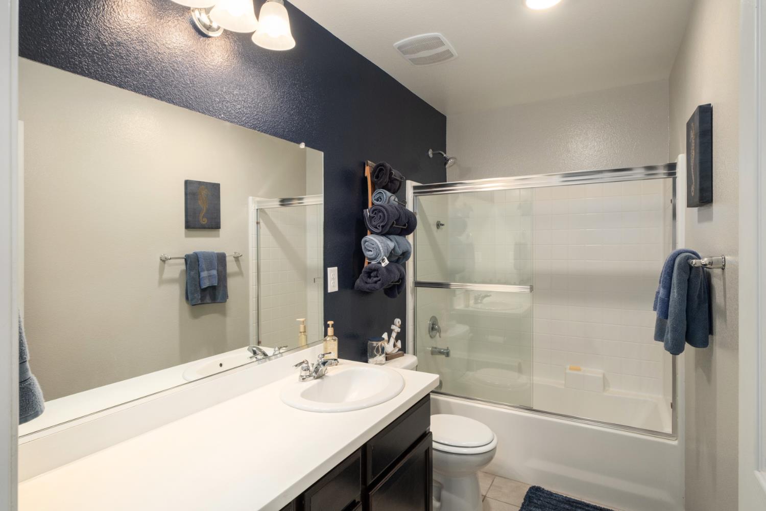 153 Drake Street Madera, CA 93638 - Photo 25 of 34 a bathroom with a sink a toilet and shower