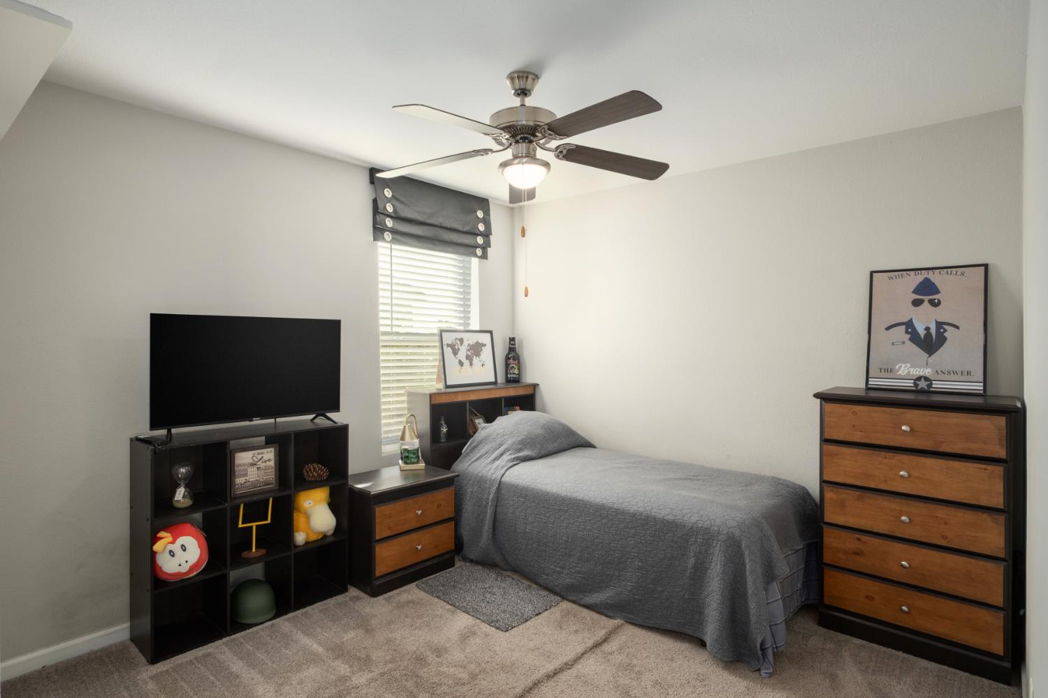 153 Drake Street Madera, CA 93638 - Photo 26 of 34 a bedroom with a bed and a flat screen tv