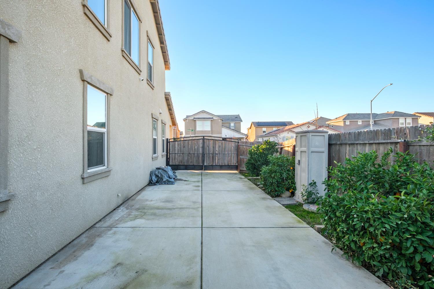 153 Drake Street Madera, CA 93638 - Photo 32 of 34 a view of a house with a small yard and large trees