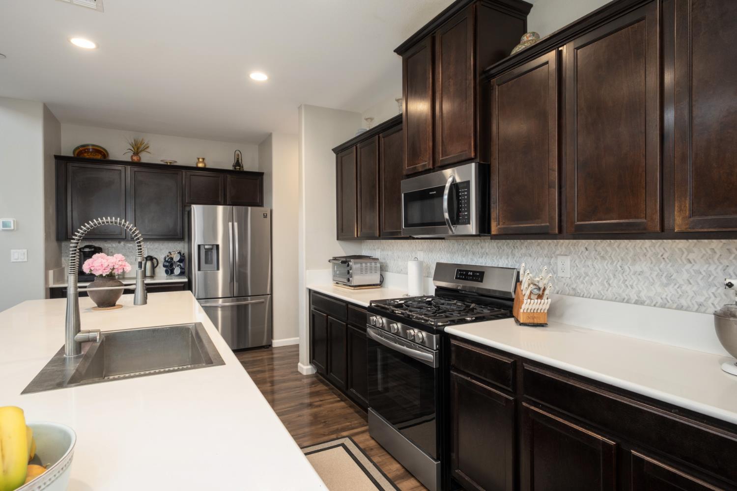 153 Drake Street Madera, CA 93638 - Photo 10 of 34 a kitchen with a sink a refrigerator and cabinets