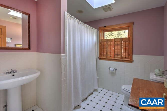 863 Lotts Road Middlebrook, VA 24459 - Photo 18 of 42 a bathroom with a sink a mirror and a shower