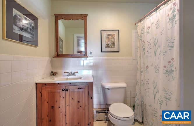 863 Lotts Road Middlebrook, VA 24459 - Photo 20 of 42 a bathroom with a toilet a sink and a mirror