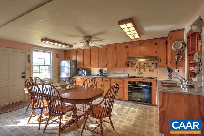 863 Lotts Road Middlebrook, VA 24459 - Photo 8 of 42 a kitchen with granite countertop a table chairs stove and cabinets