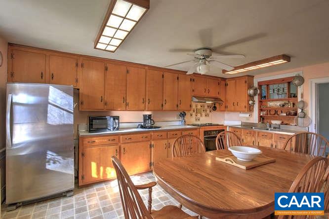 863 Lotts Road Middlebrook, VA 24459 - Photo 9 of 42 a kitchen with stainless steel appliances granite countertop a sink a stove a dining table and chairs with wooden floor