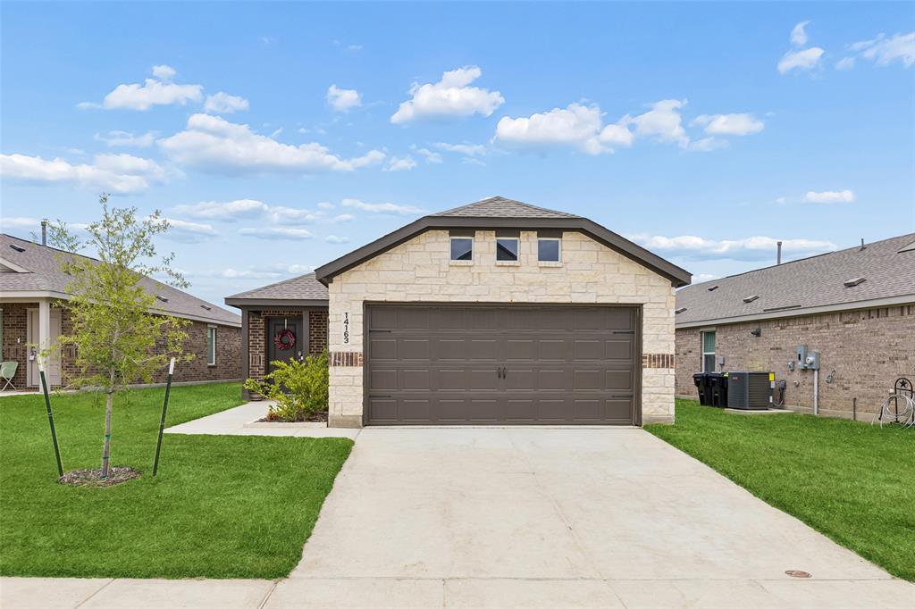 14163 Kempt Drive Pilot Point, TX 76258 - Photo 2 of 29 Charming curb appeal and like-new construction welcome you home at 14163 Kempt Drive - Featuring a timeless stone-and-brick elevation, manicured lawn, and inviting front entry.