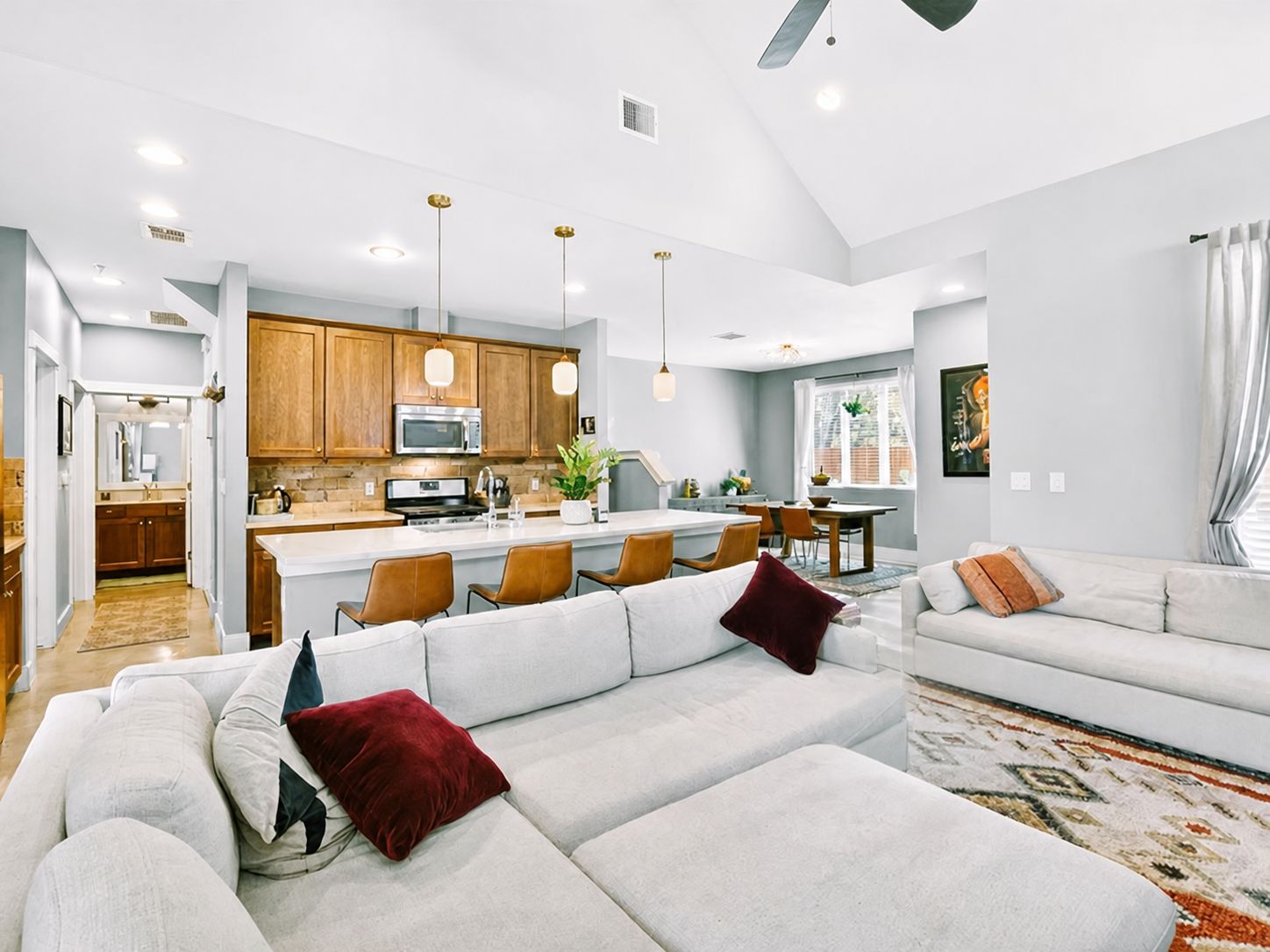 4917 Sunset Trail, Unit A Austin, TX 78745 - Photo 1 of 35 Open-concept living space featuring a vaulted ceiling and recessed lighting