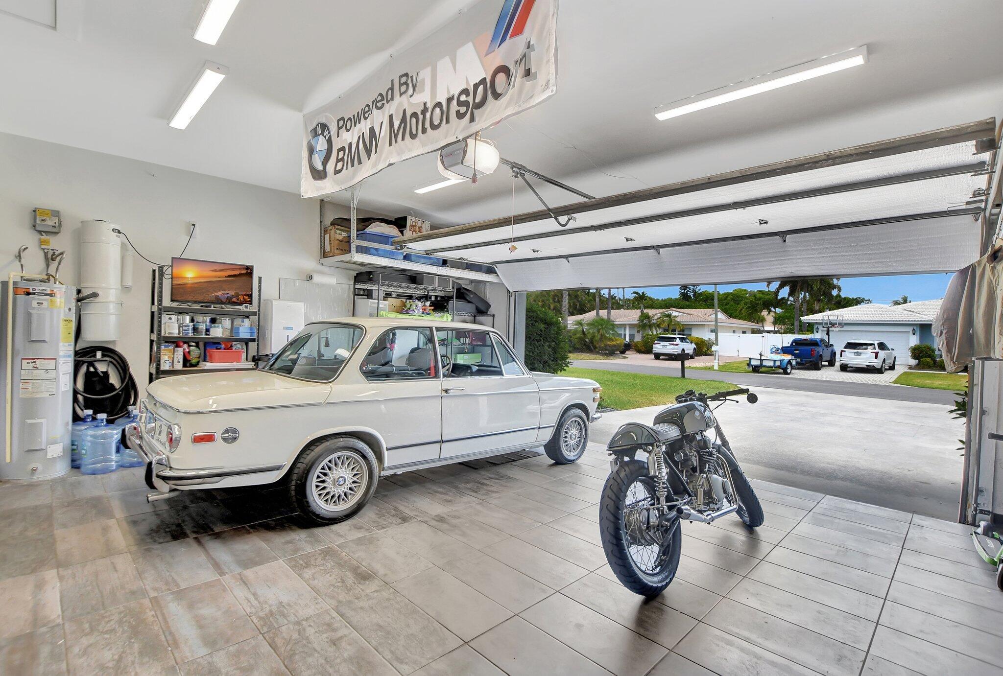 1980 North Conference Drive Boca Raton, FL 33486 - Photo 54 of 55 a car and bike parked in a garage