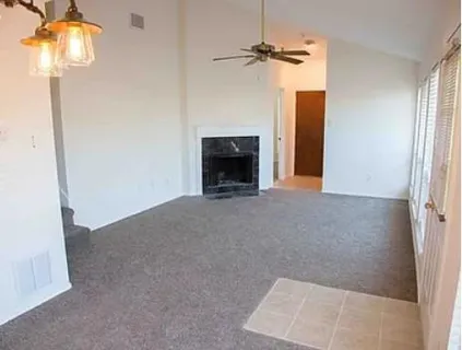 a view of an empty room with a fireplace