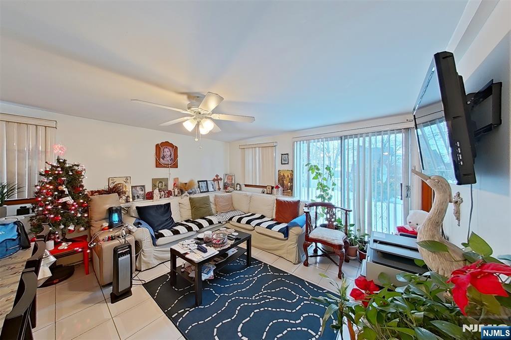 311 Marvin Avenue Hackensack, NJ 07601 - Photo 13 of 39 a living room with lots of furniture and a flat screen tv
