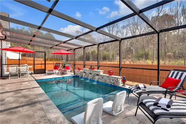 a view of a patio with a dining table and chairs with wooden floor