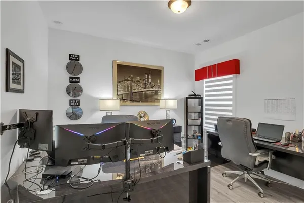 a balcony with chairs and a potted plant