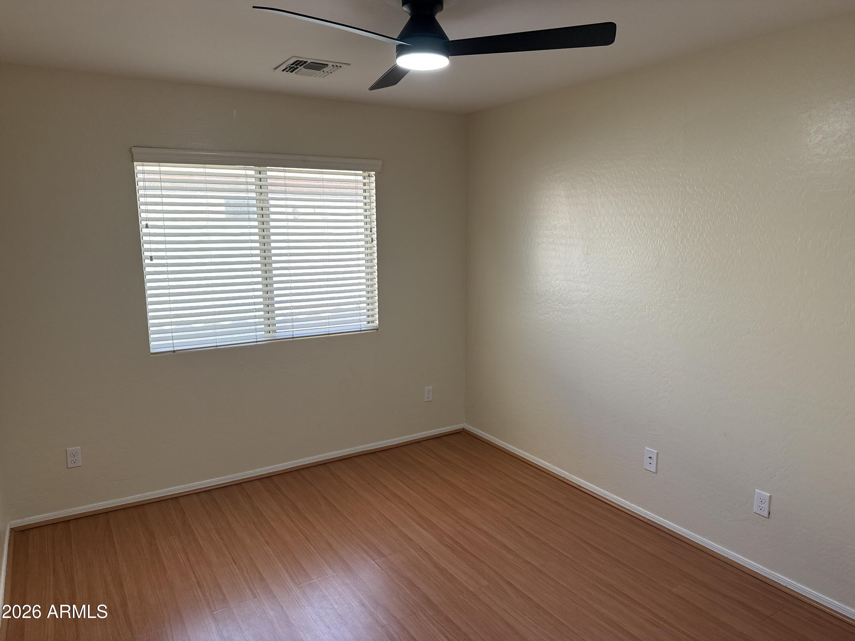 9630 West Reno View Drive Peoria, AZ 85345 - Photo 14 of 21 an empty room with wooden floor and windows
