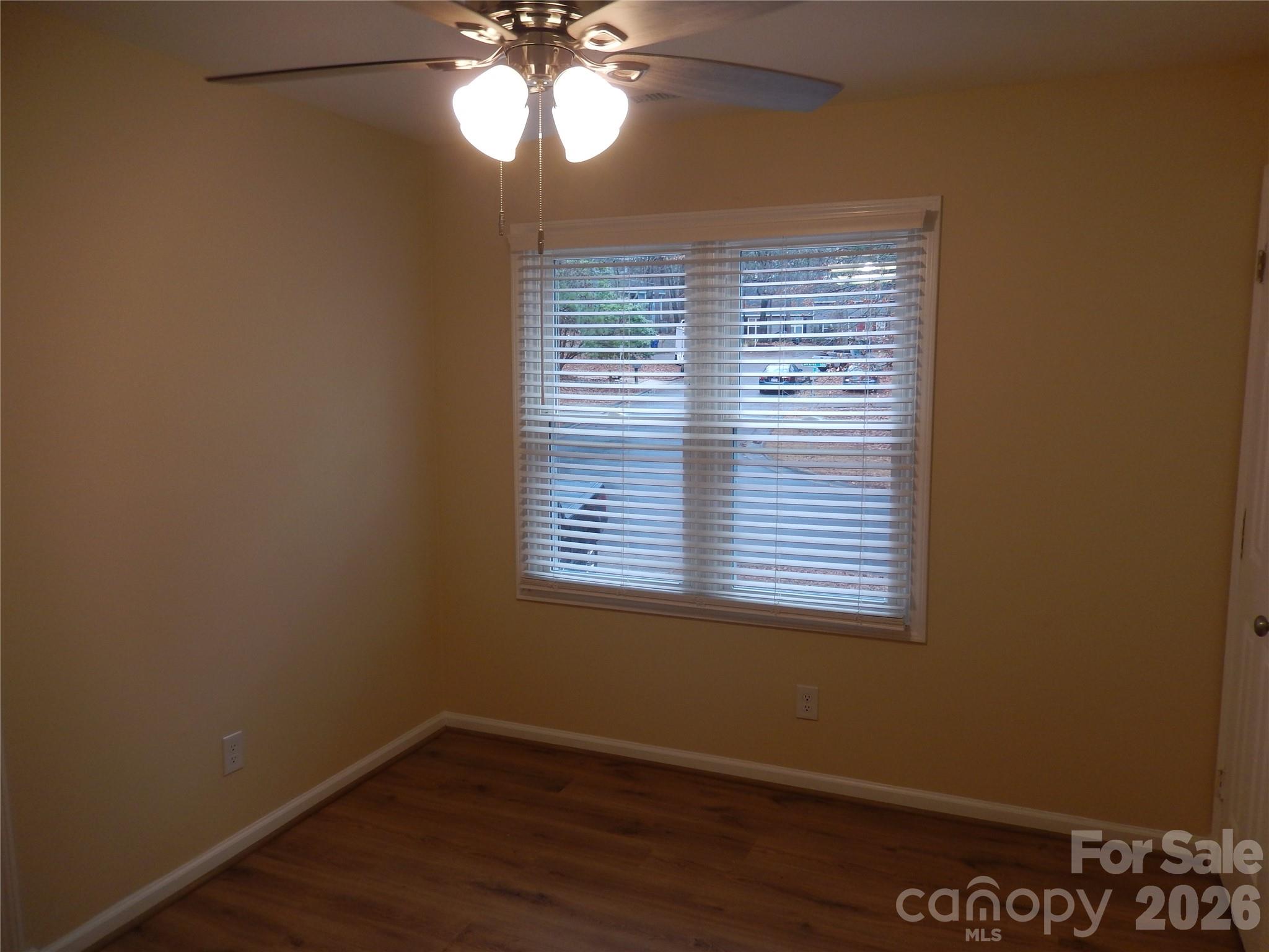 547 Brent Road Raleigh, NC 27606 - Photo 8 of 15 a view of an empty room with wooden floor and a window